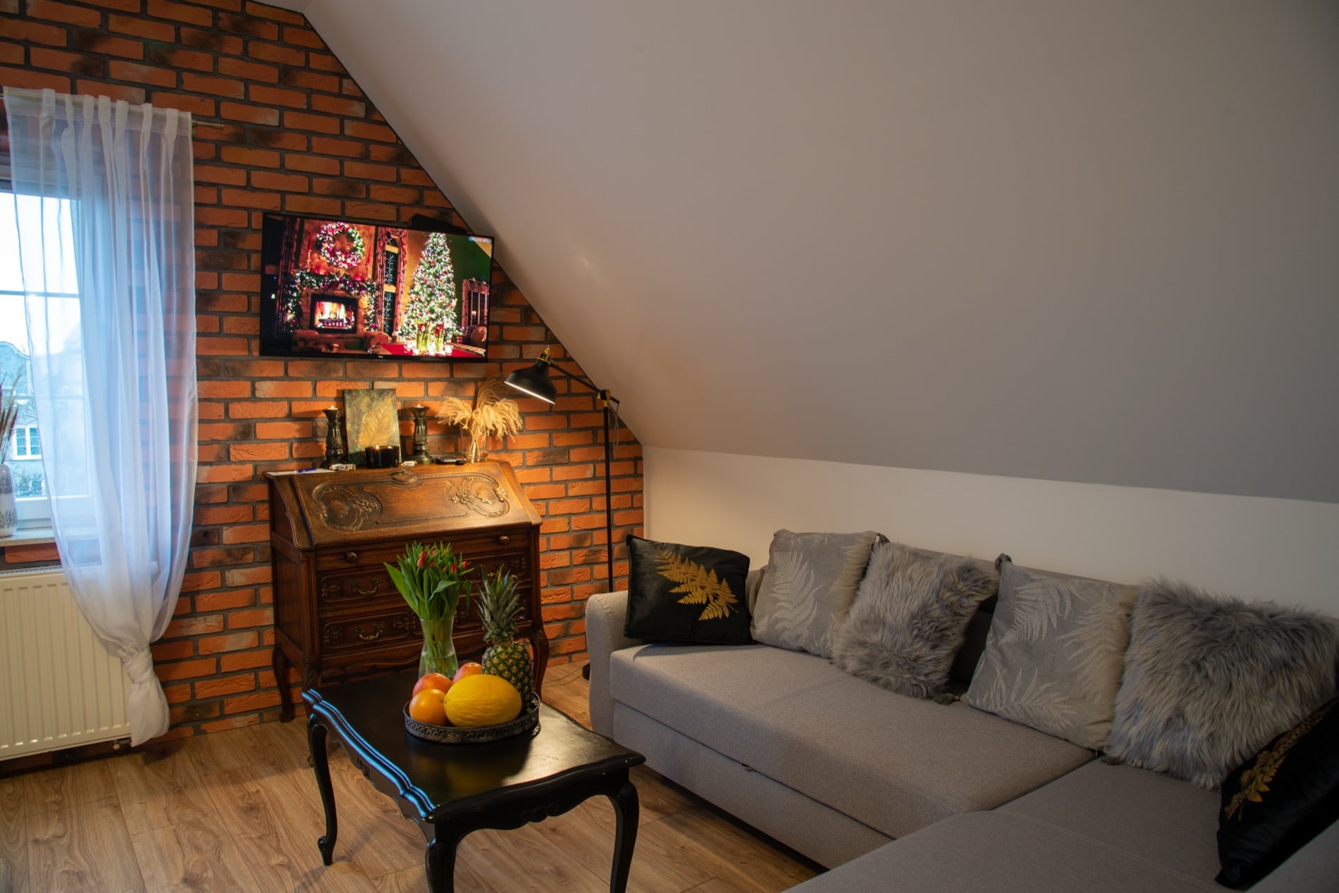 Długa 66 Attic apartment with exposed brick and sloped ceilings in Gdańsk Old Town